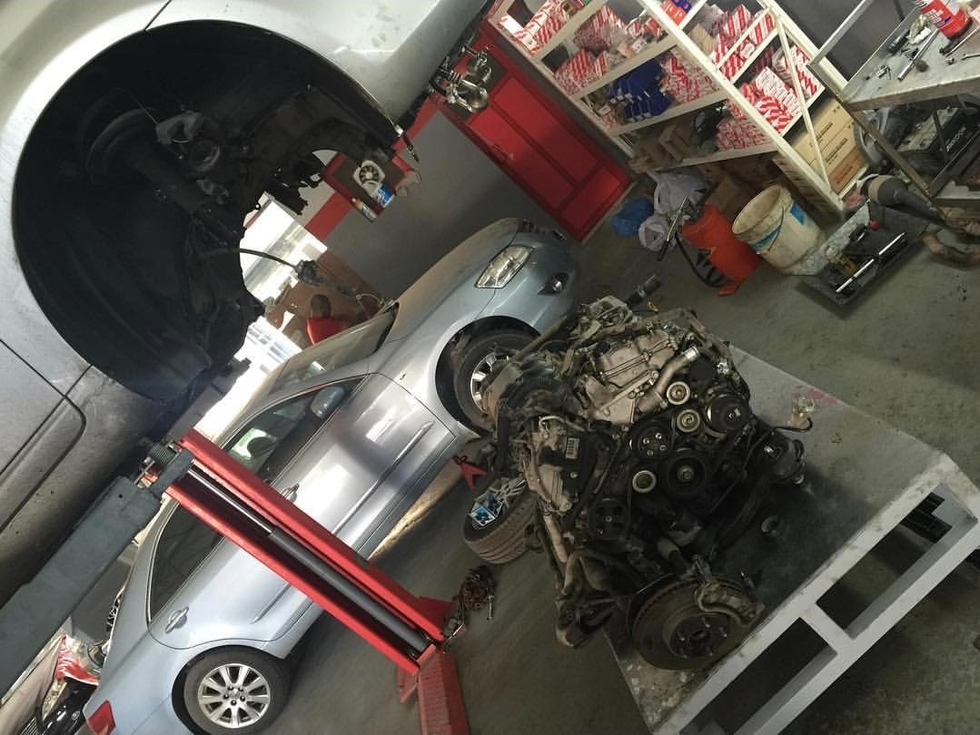 White vehicle on an alignment lift